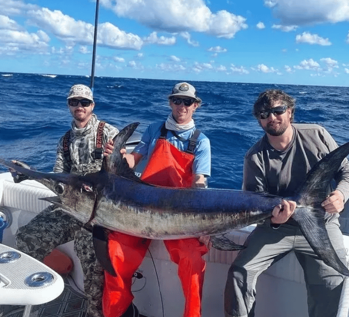 Angler holding fresh reef catch on boat deck