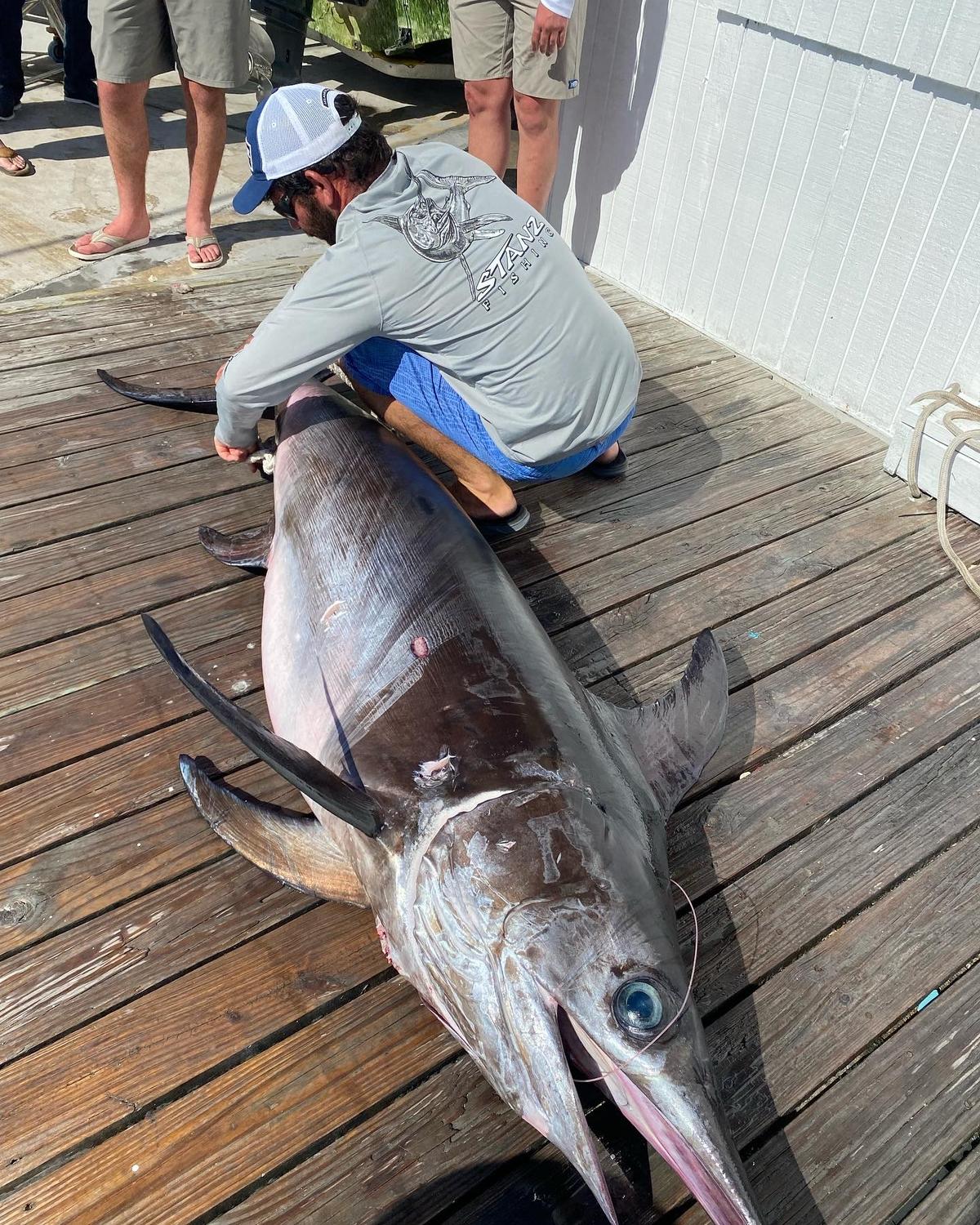 Captain and crew guiding guests on successful fishing trip
